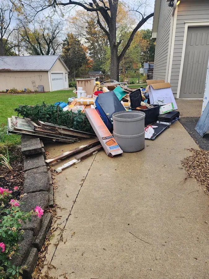 Dumpster being loaded with debris for Estate Cleanout Dumpster Rental in Gulf Breeze